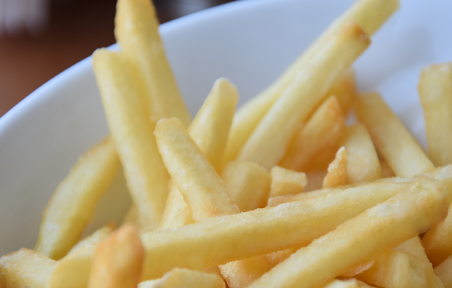 Photo of crispy yellow French fries from Clay restaurant's appetizer menu