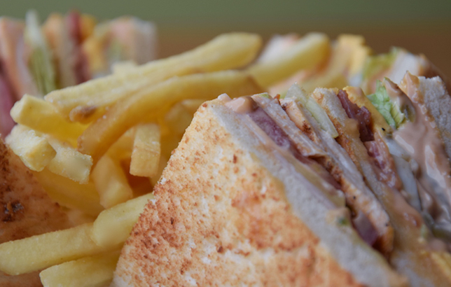 Image of chicken club sandwich with fries from Clay's bites and wraps menu