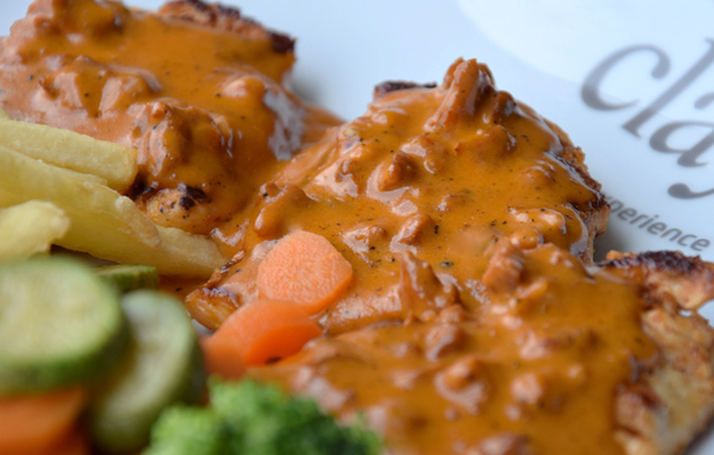 Image of grilled chicken breast with spicy Chorizo sauce and fries from Clay restaurant's platters menu