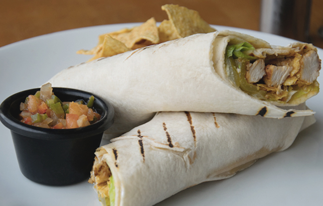 Image of grilled chicken wrap with pickles, lettuce, tortilla chips, and marinara sauce from Clay restaurant's sandwiches and wraps menu