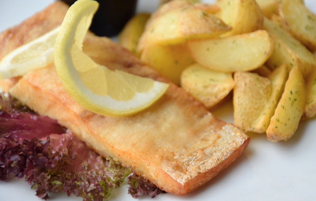 Photo of grilled fish with potato wedges from the platters section of Clay's menu