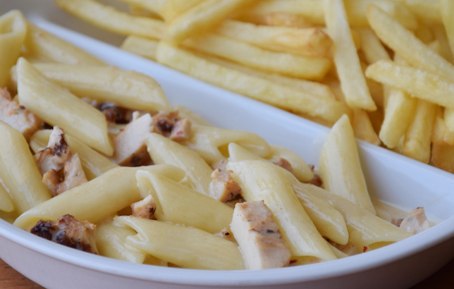Image of chicken pasta and white sauce with fries from Clay restaurant's kids meal section of the menu