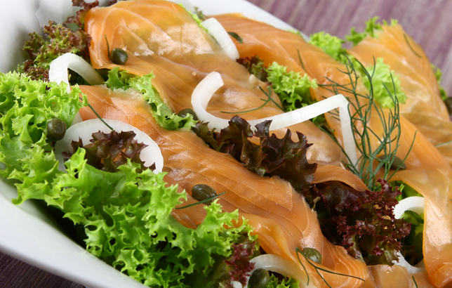 Image of smoked salmon salad with capers, onions, and iceberg lettuce from Clay restaurant's salads menu