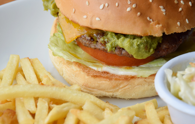 Image of burger with guacamole mix, tomato, cheddar cheese, beef patty, jalapenos, lettuce, and sauce from Clay restaurant's burgers menu.