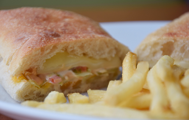 Image of cheese sandwich in Ciabatta bread with a side of french fries from Clay restaurant's bites and wraps menu