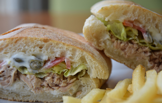 Image of Tuna Ciabatta sandwich including lettuce, tomatoes, and mayonnaise sauce.