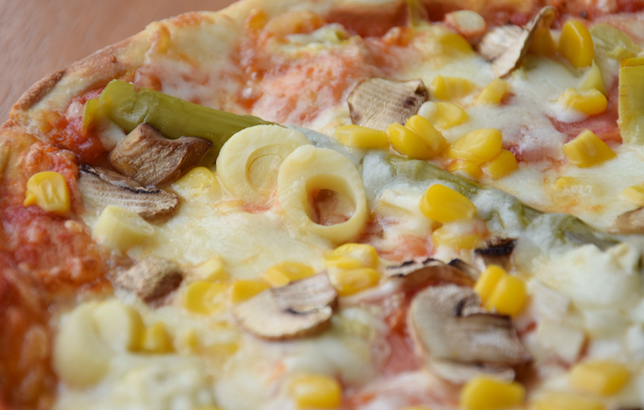 Image of Italian pizza with asparagus, sweet corn, mushrooms, and palmetto.