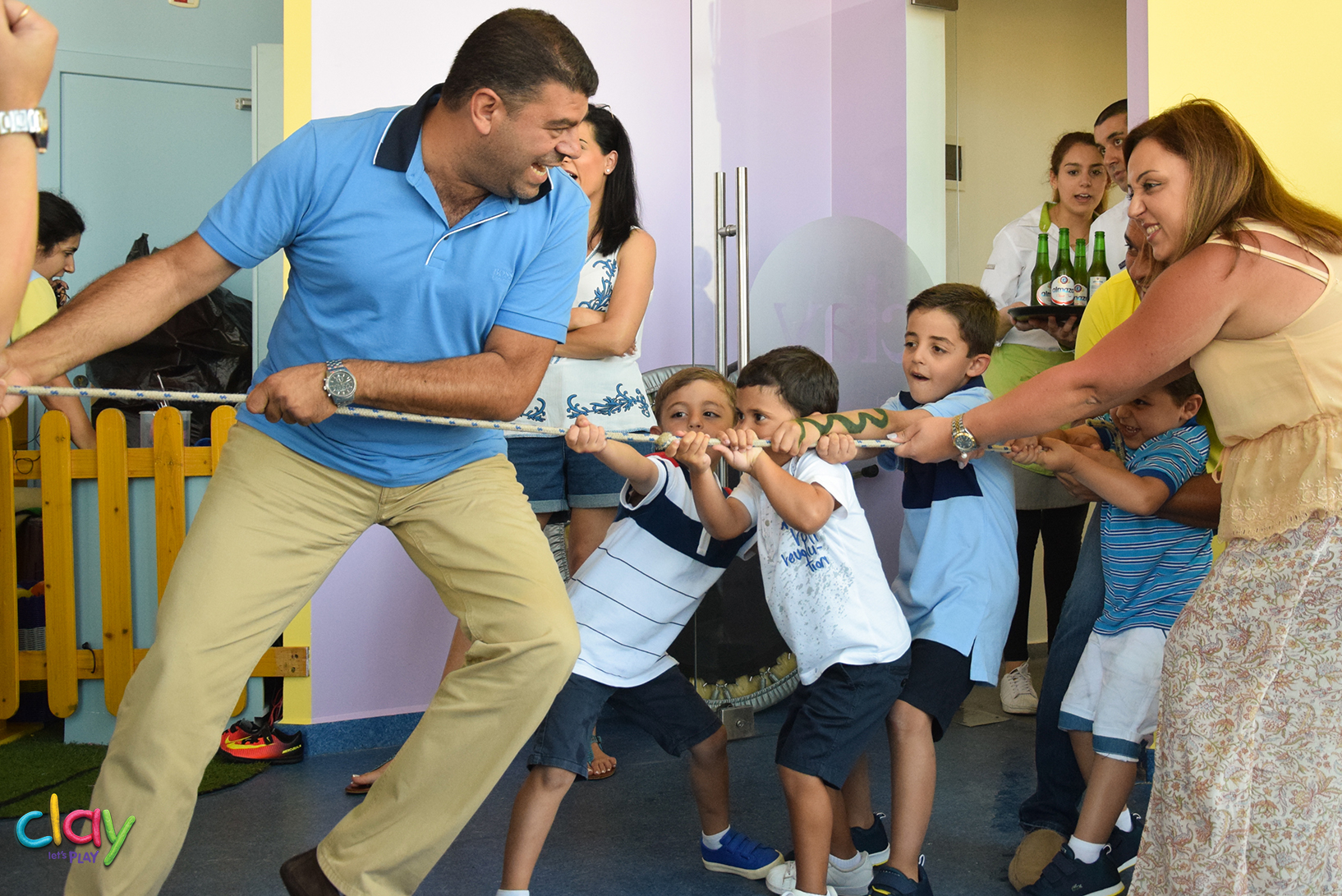 Image of children and parents play rope war