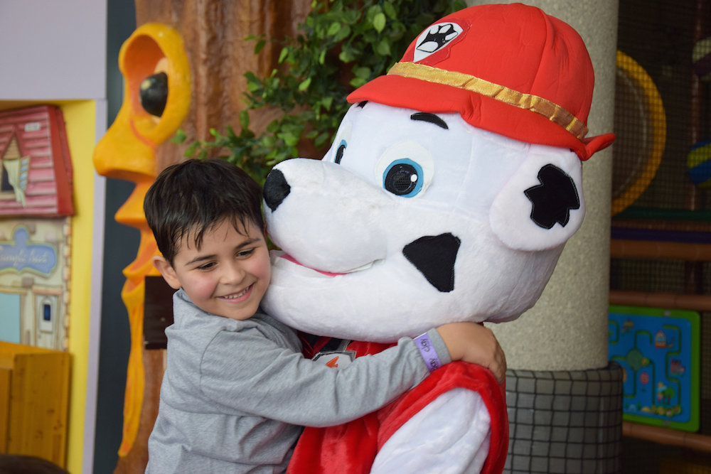 Image of young boy hugging a paw patrol character at Clay Let's Play