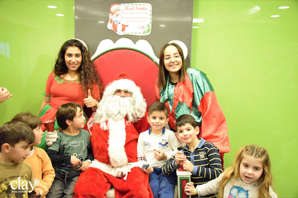 Photo of Santa with children from Clay restaurant's Christmas event