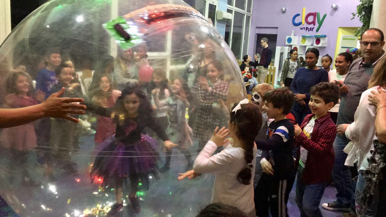 Image of a girl at our hamster ball roll event in Clay restaurant's playground